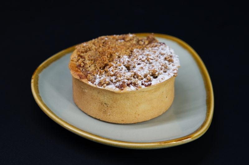 A round apple pie with a sourdough crumble top